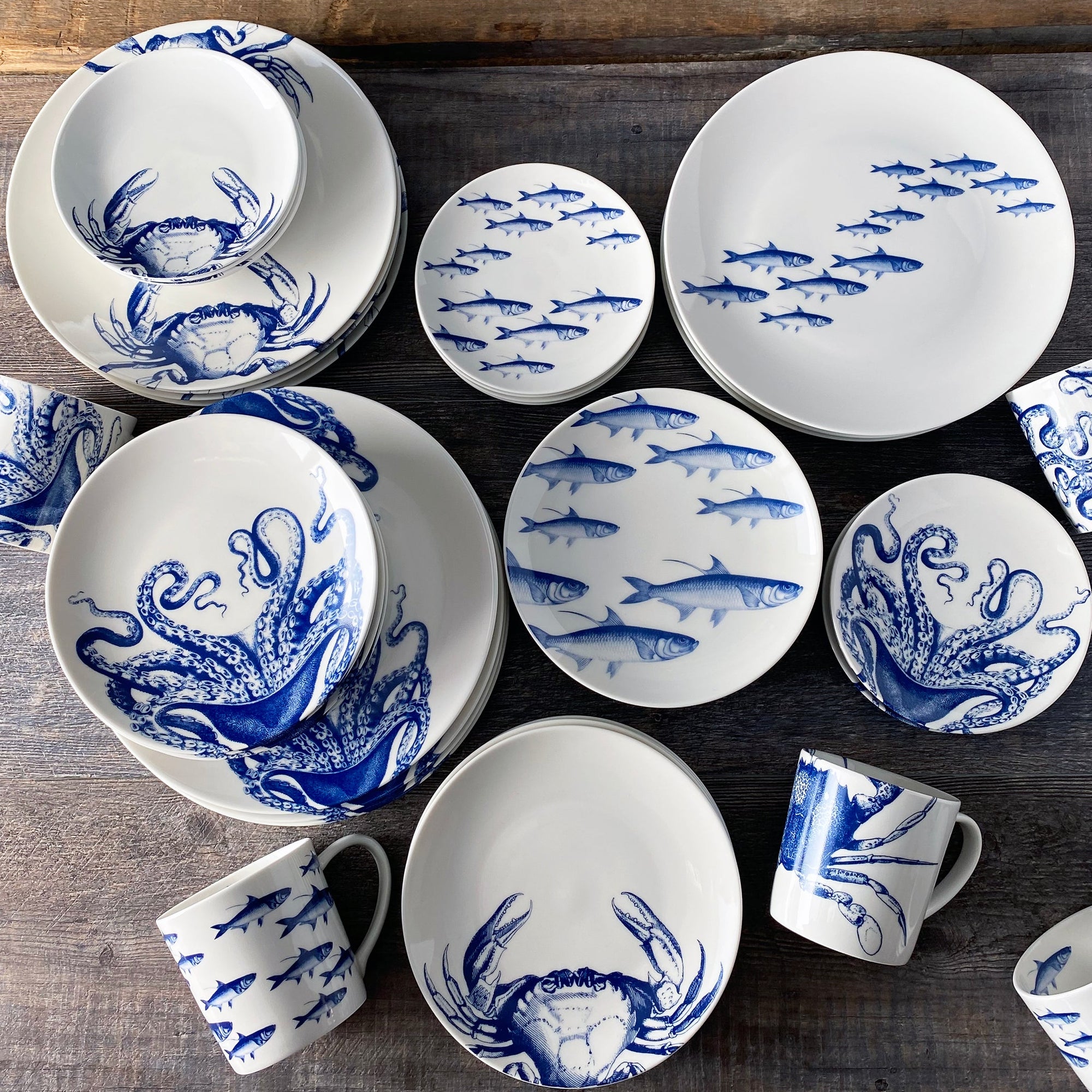 A set of blue and white plates with crabs on them.