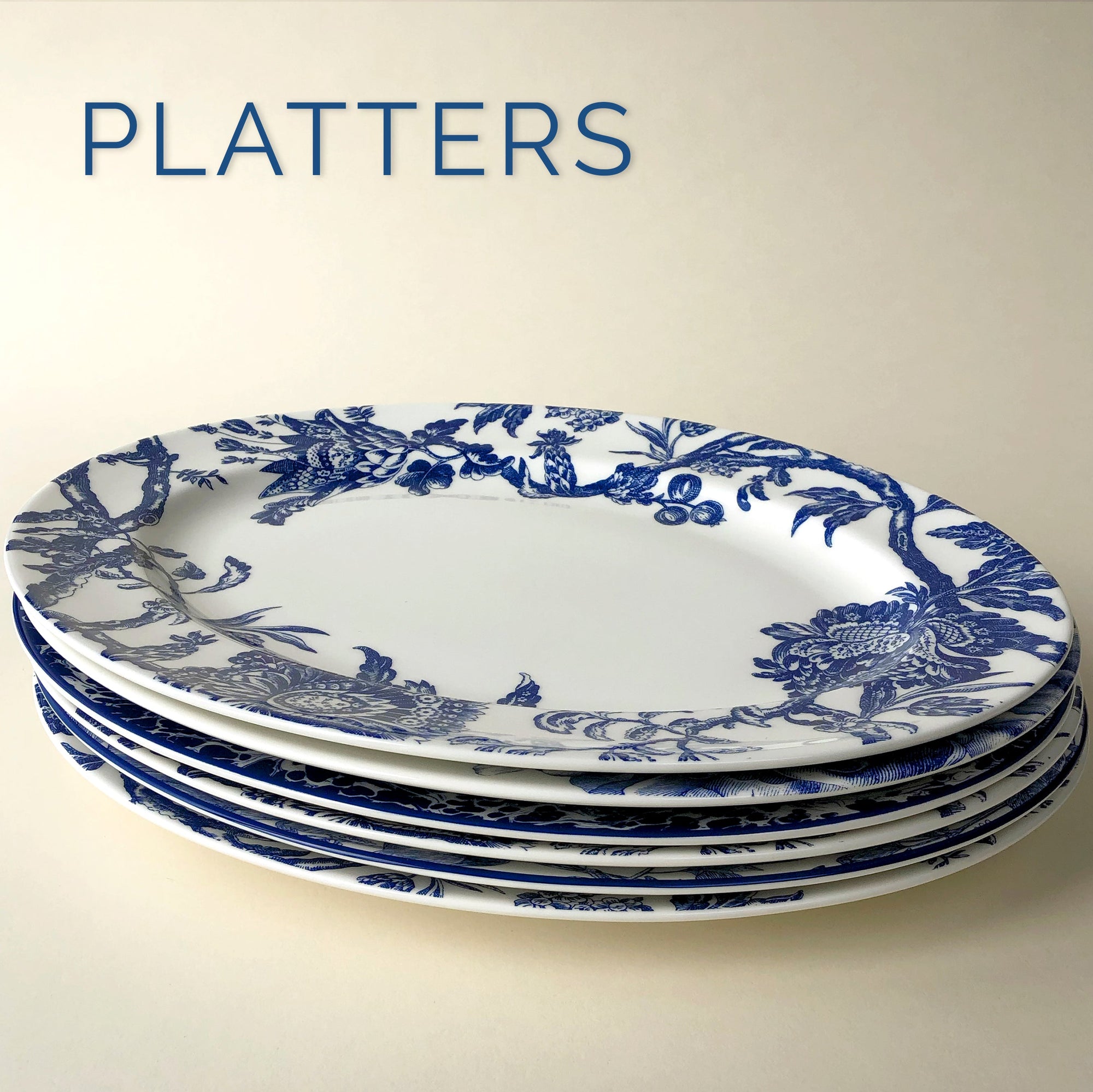 A stack of blue and white plates with the words platters.