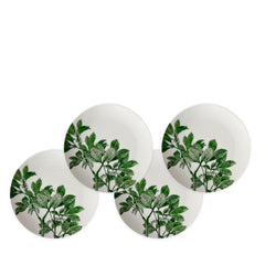 Four Caskata Arbor Green Small Plates with green leaf patterns are arranged in a semi-overlapping manner, creating a delightful botanical dinnerware display.
