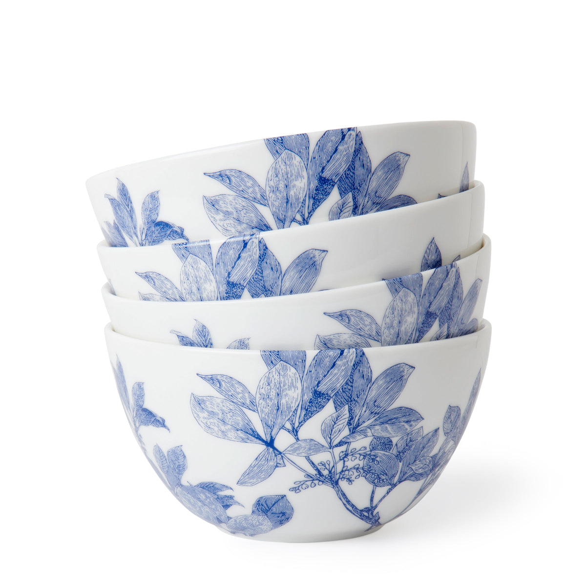 A stack of four Arbor Cereal Bowls by Caskata, featuring a tall slanted silhouette ideal for cereal, with blue floral and leaf patterns.