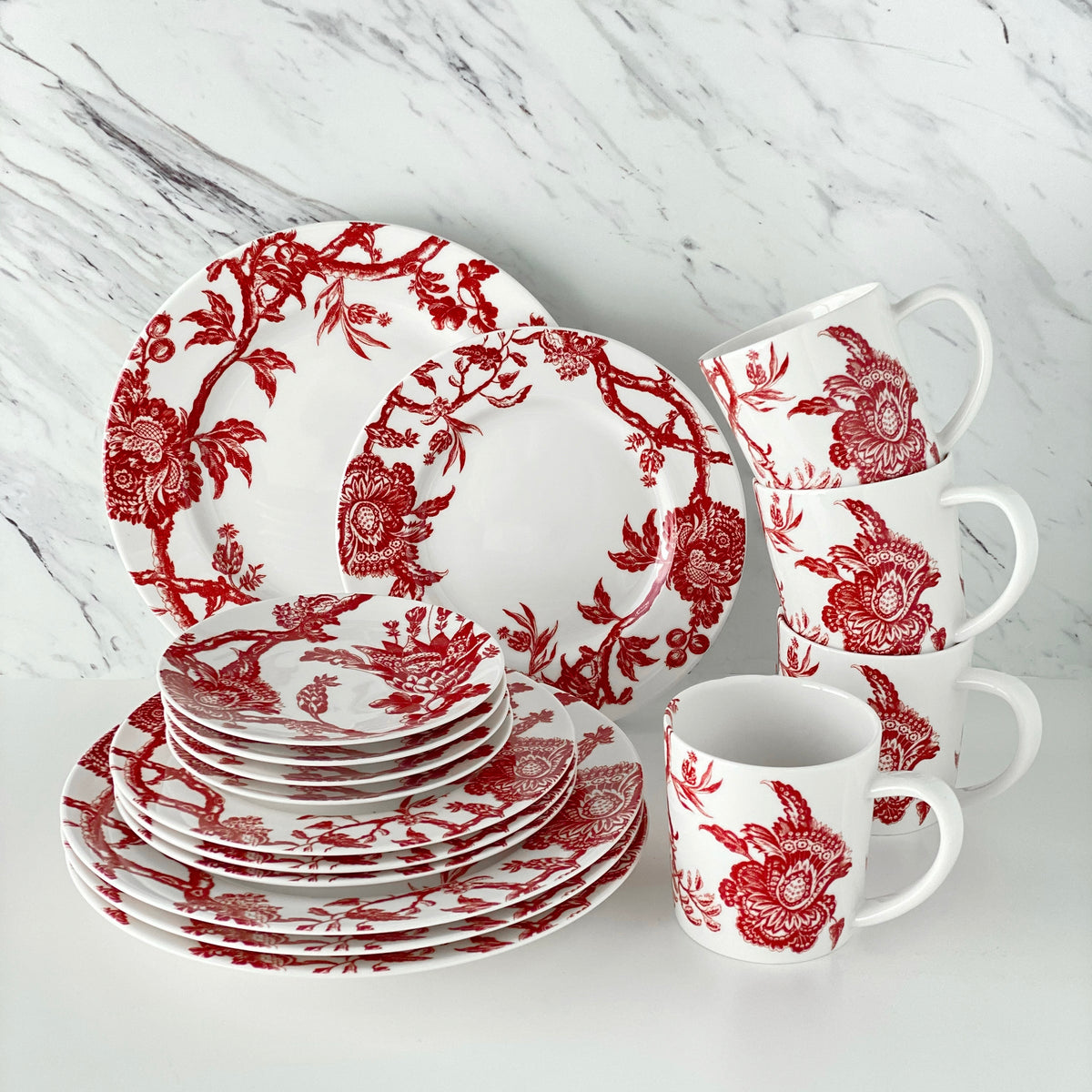 The red and white porcelain Arcadia Crimson 16 Piece Dinnerware Set from Caskata includes 4 each of salad, dinner and canape plates as well as four wide mouth mugs.