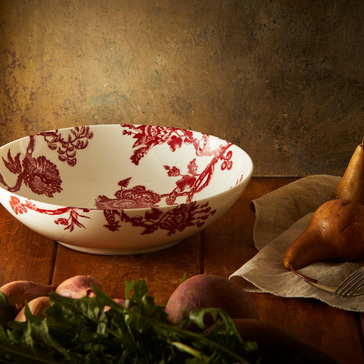 Arcadia Crimson Wide Serving Bowl by Caskata, shown here on a rustic table with pears.