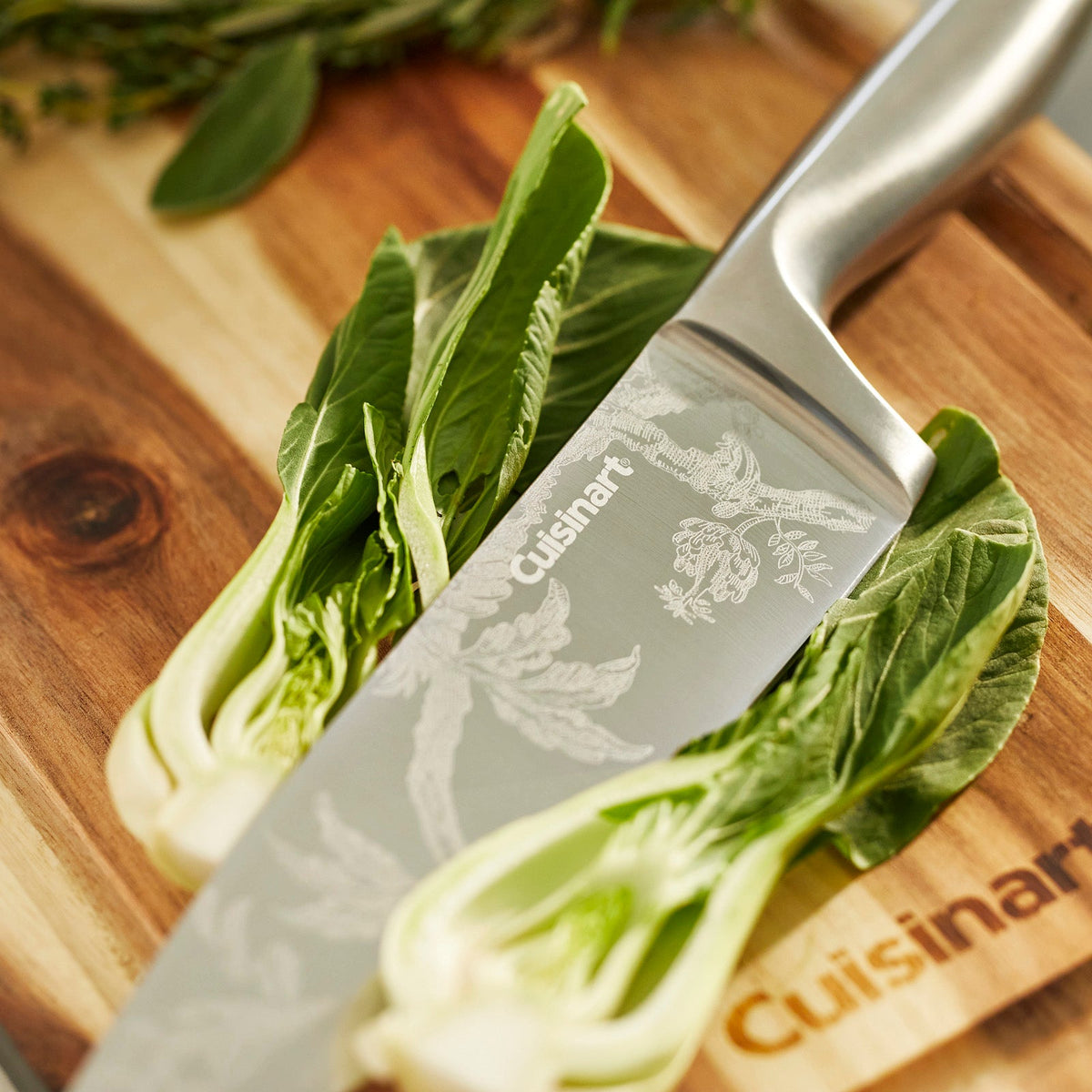 A Caskata X Cuisinart Limited Edition Arcadia 15 pc. German Stainless Steel Cutlery Block with a floral pattern on a Cuisinart cutting board.