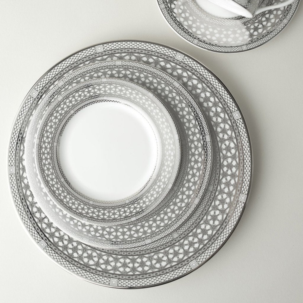 A set of Caskata Artisanal Home Hawthorne Ice Platinum Salad Plates on a white surface.