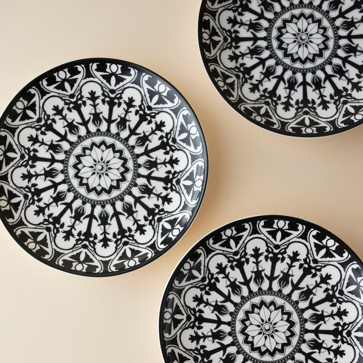 Three Casablanca Canapé Plates from the Caskata Artisanal Home Geometrics Collection with designs on them.
