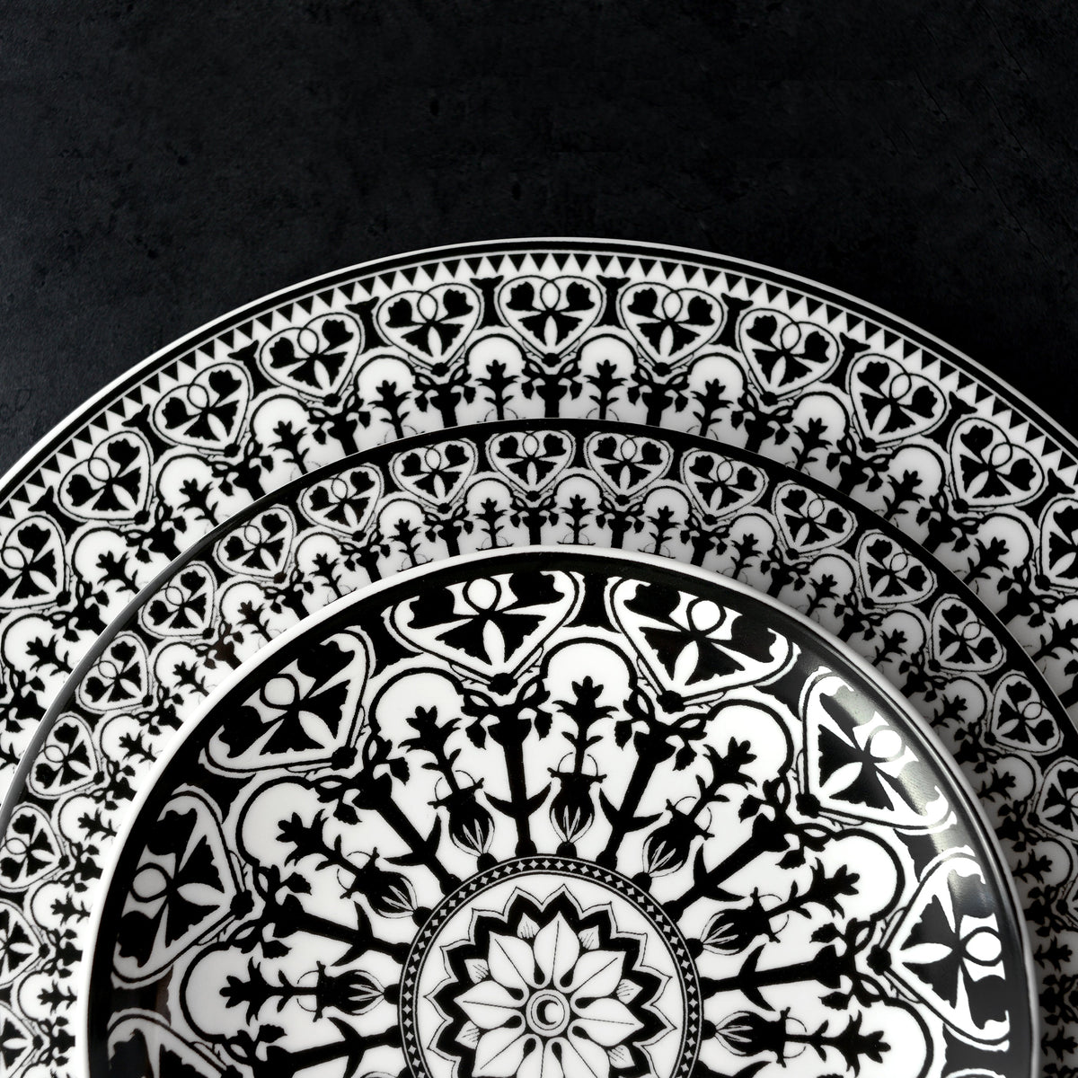 A black and white Casablanca Canapé plate with an ornate pattern from the Geometrics Collection by Caskata Artisanal Home.