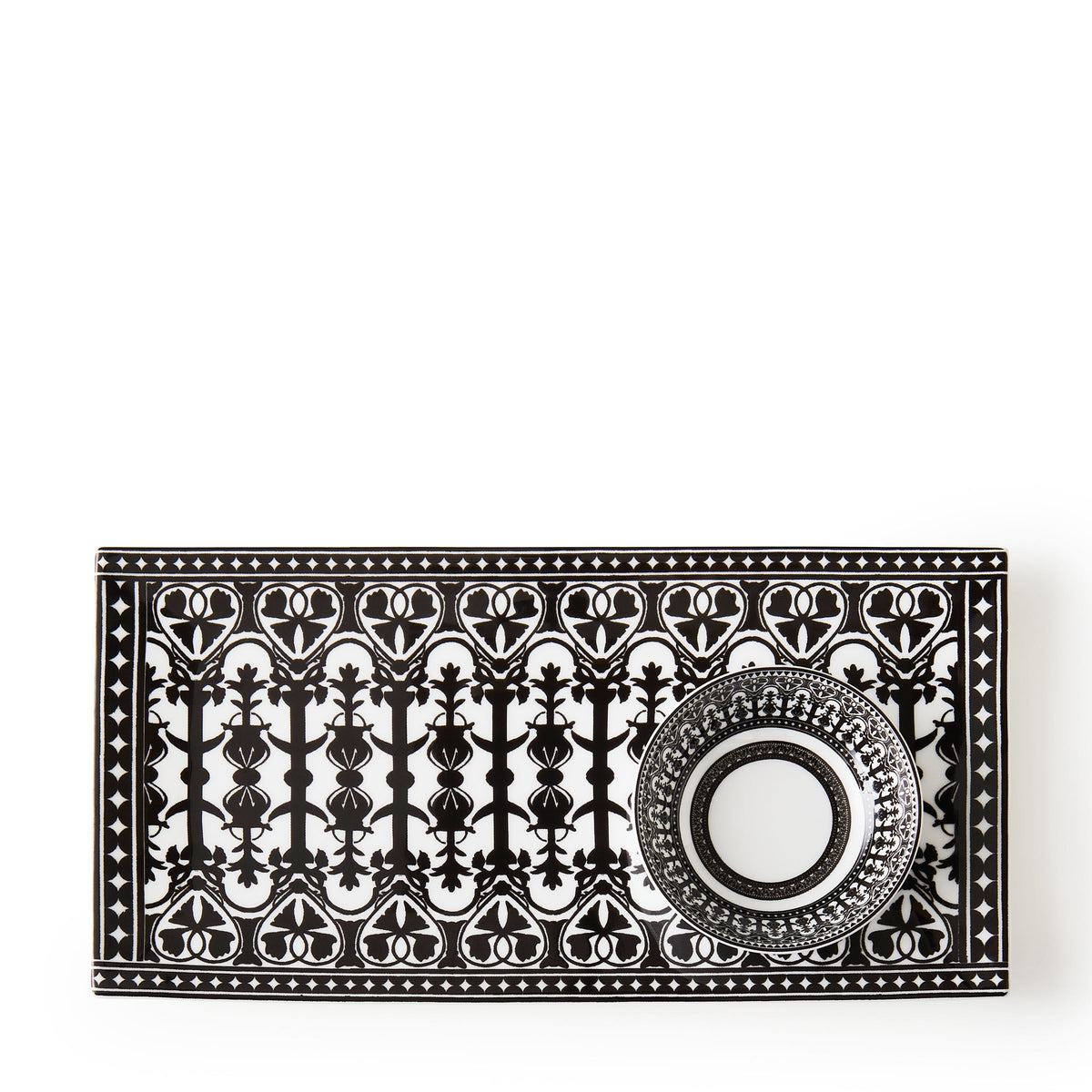 A black and white patterned rectangular plate with an intricately designed cup placed on it, both featuring symmetrical geometric and heart motifs, reminiscent of Caskata&#39;s Casablanca Dipping Dishes, Set of 4.