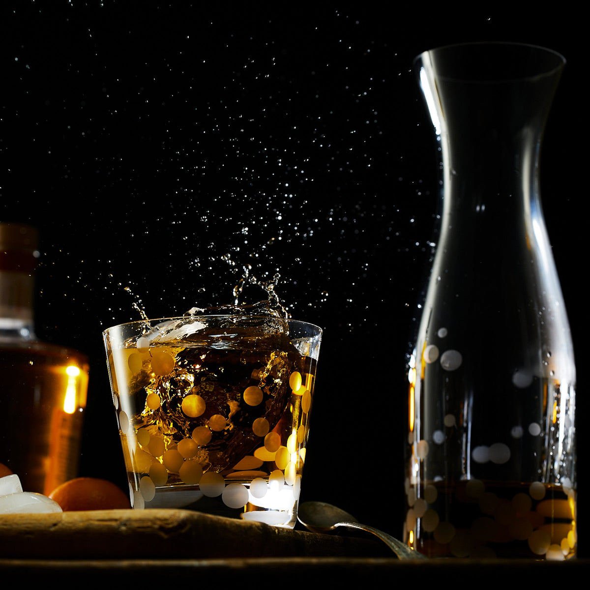 A Chatham Pop Carafe by Caskata filled with whiskey, accompanied by a glass of water.