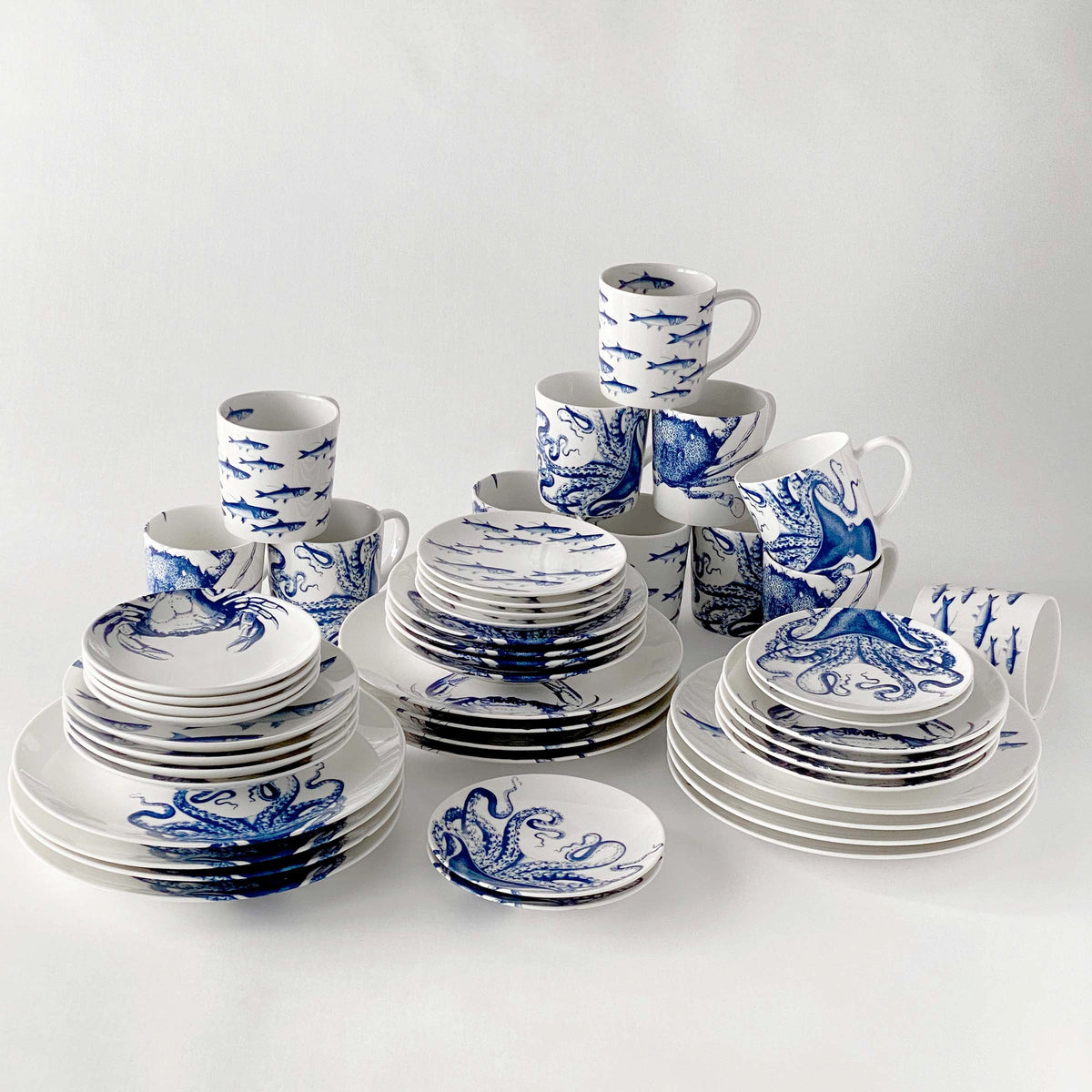 A set of Coastal Collection 48 Pc. Set dishes with intricate patterns on a white surface by Caskata Artisanal Home.