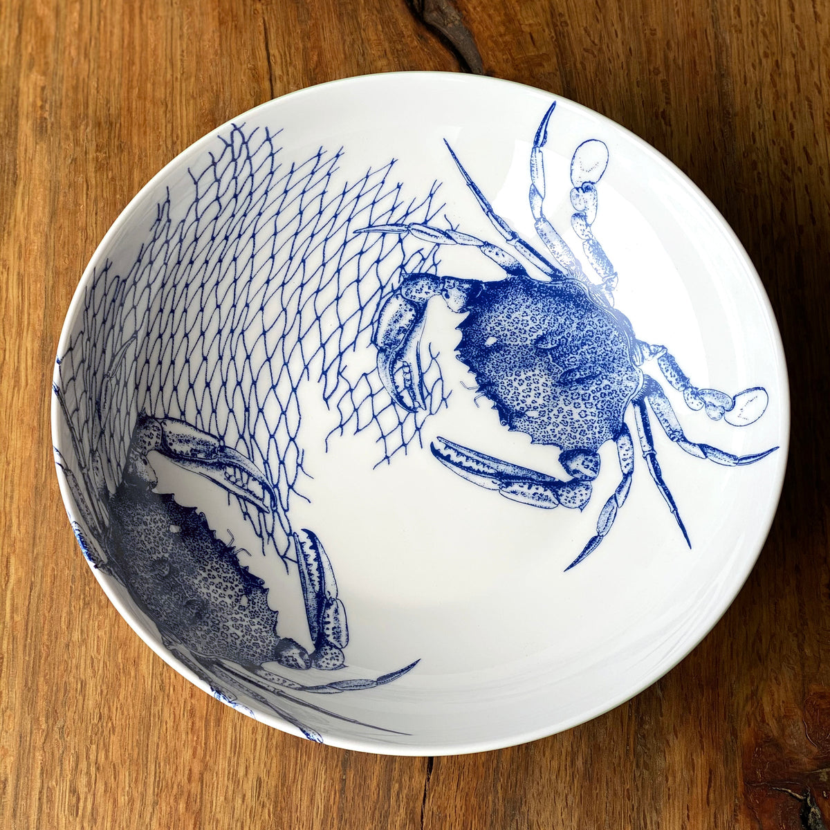 A Crab Wide Serving Bowl with a crab on it by Caskata Artisanal Home.