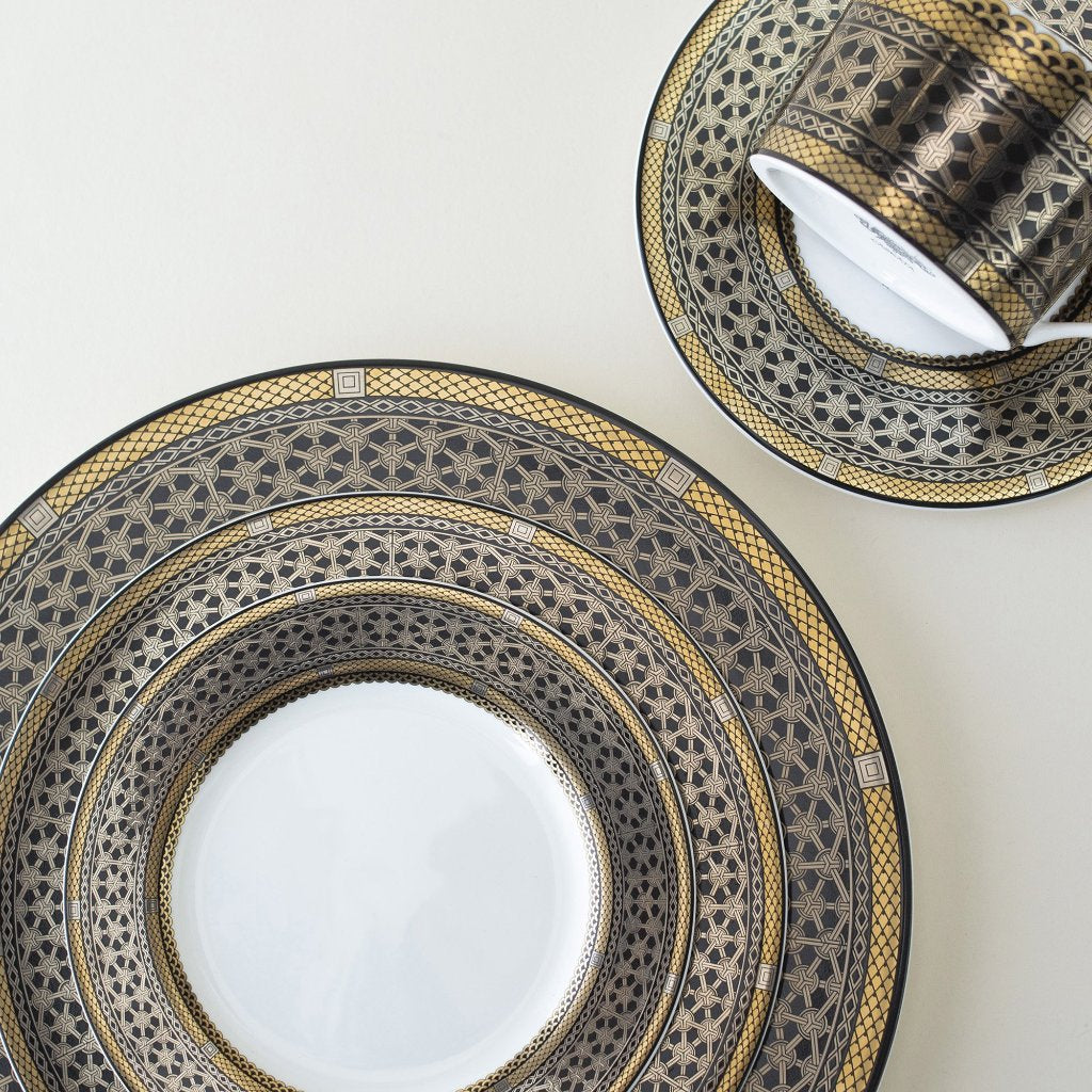 The Hawthorne Onyx Gold &amp; Platinum 5-Piece Place Setting by Caskata Artisanal Home is elegantly displayed on a white surface.