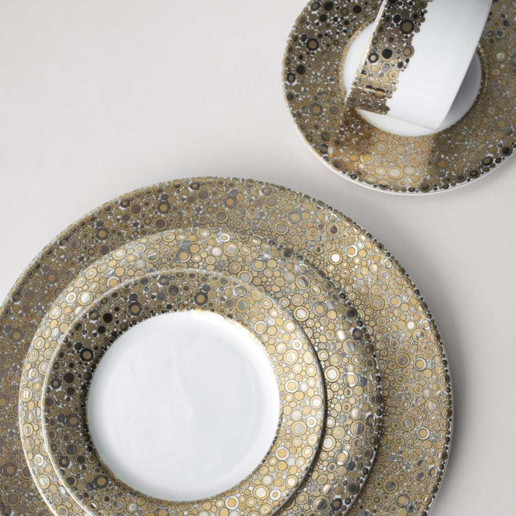 A set of Caskata Artisanal Home Ellington Shimmer Gold &amp; Platinum 5-Piece Place Setting arranged on a white surface, ideal for a stunning table setting.