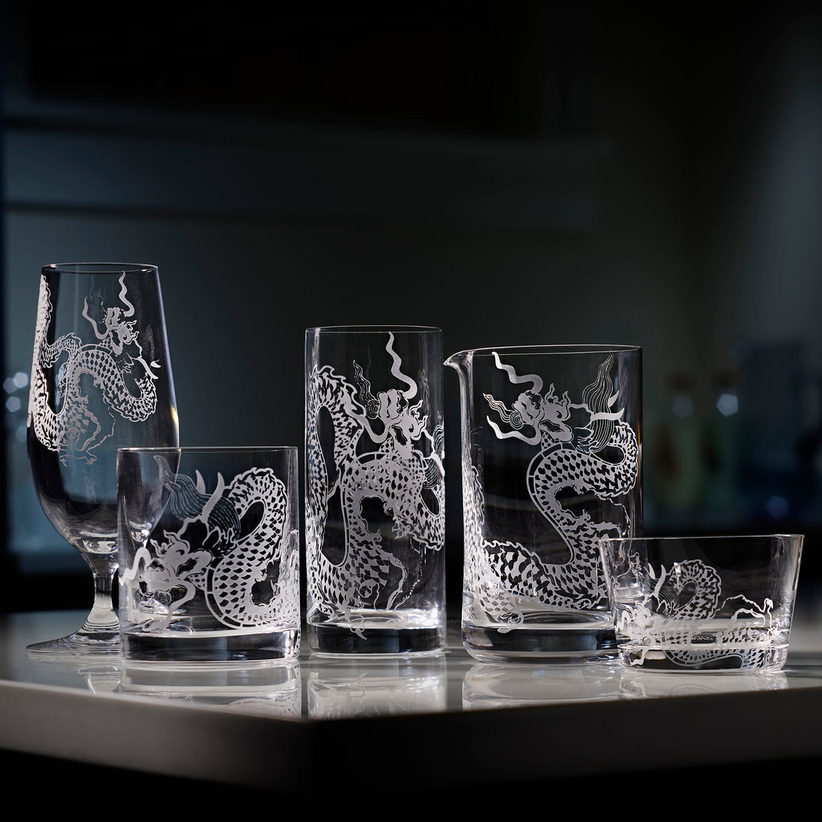 The sand etched dragon collection by Caskata includes a beer glass, tumbler, highball, mixing glass and tidbit bowls.