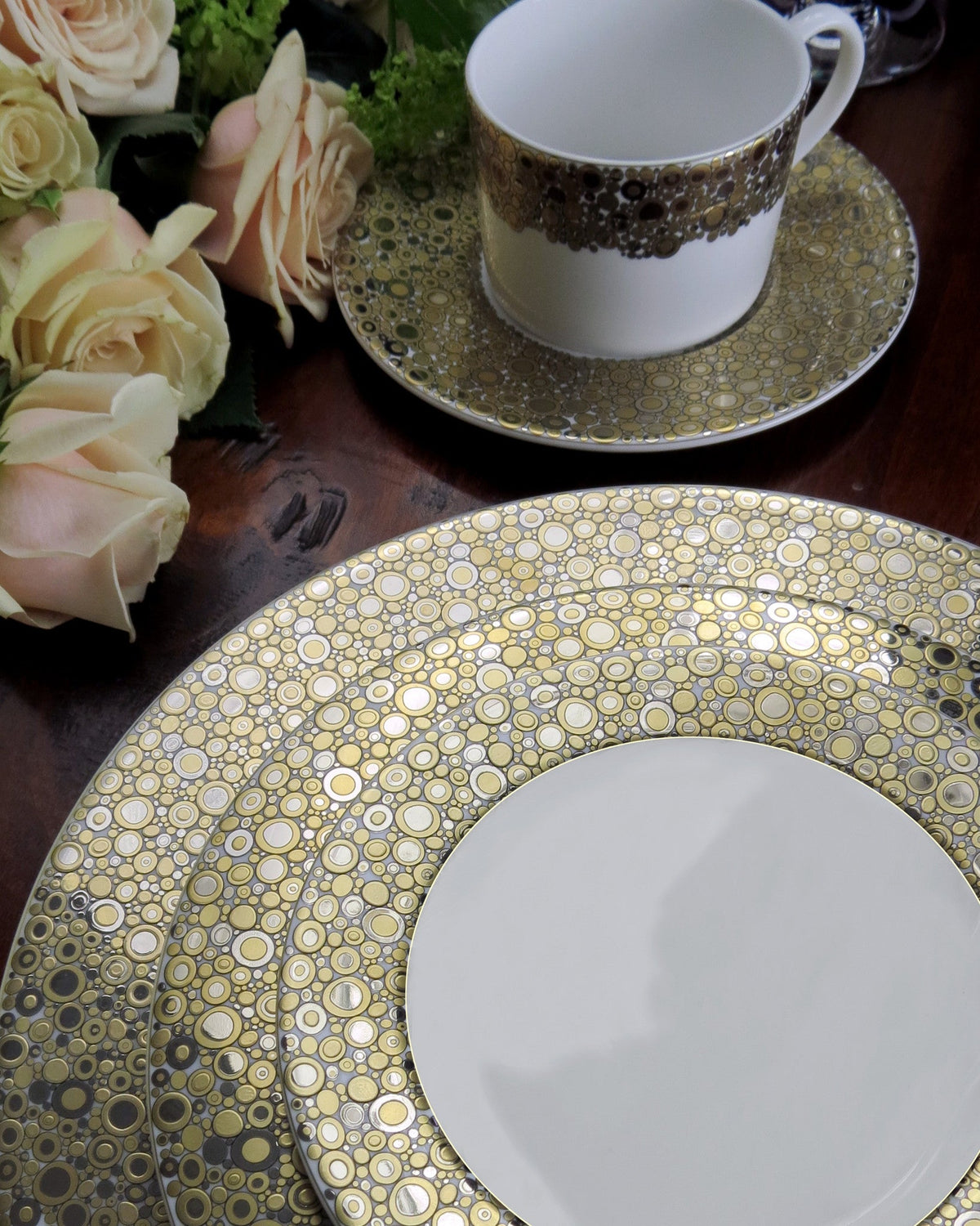 A set of Ellington Shimmer Gold &amp; Platinum Rimmed Soup Bowls and cups from Caskata Artisanal Home, arranged elegantly on a table.