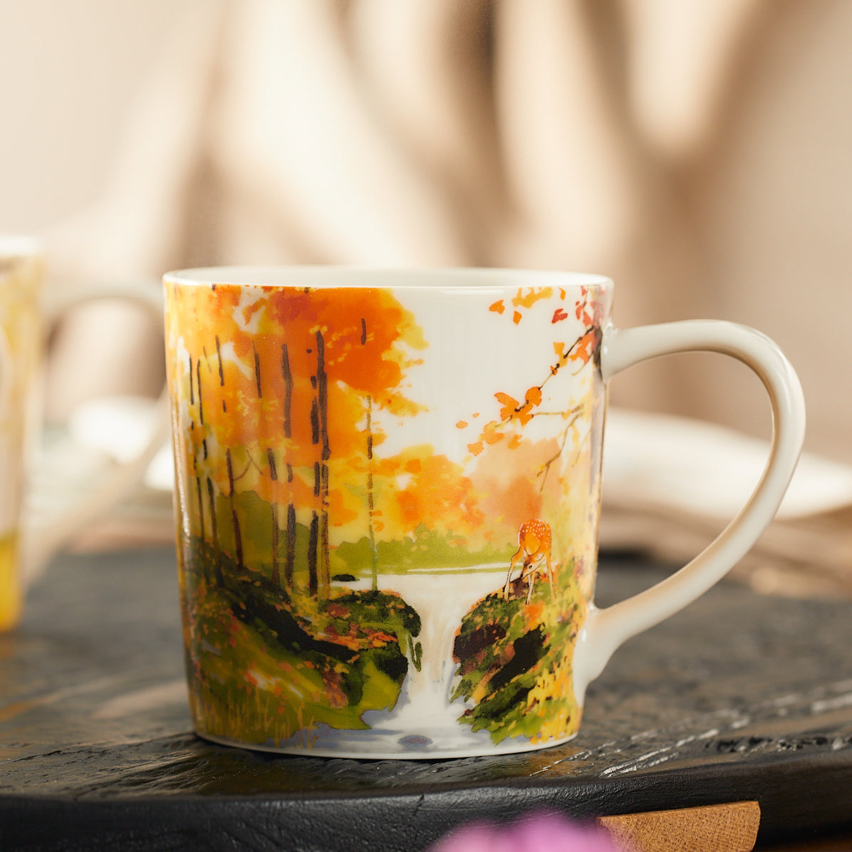 A close up of the fall foliage and waterful design on the Caskata X Felix Dolittle Autumn Collaboration Porcelain Mug Set of 4