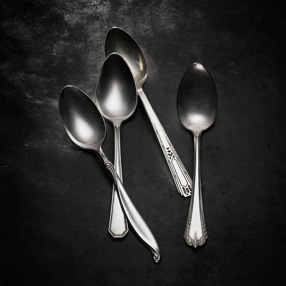Caskata Brimfield Vintage Teaspoons displayed on a black surface, appealing to antique lovers in New England.