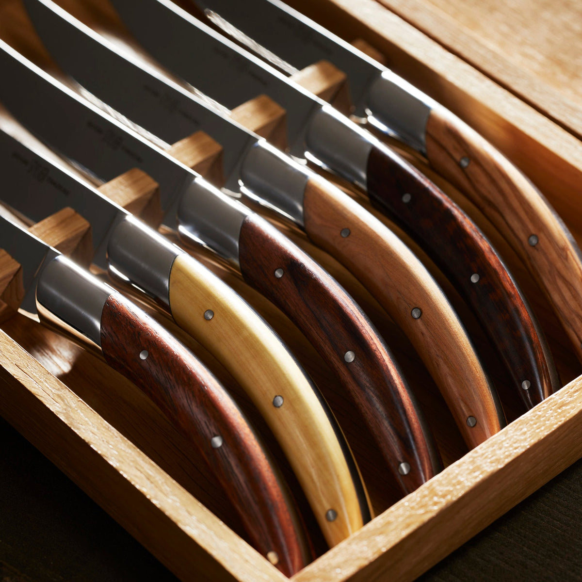 A Goyon-Chazeau Styl&#39;ver Mixed Wood Steak Knives Boxed Set/6 in a handmade wooden box.