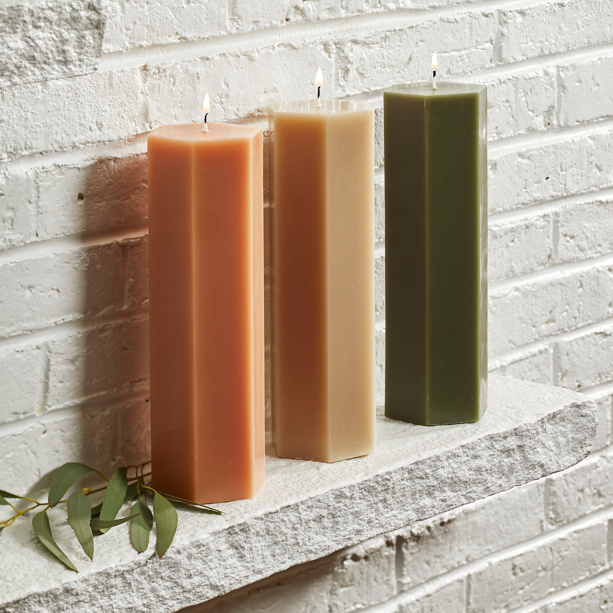 The Hexagonal Pillar Candle in Parchment 9 inch from Caskata is also available in petal pink and moss green.