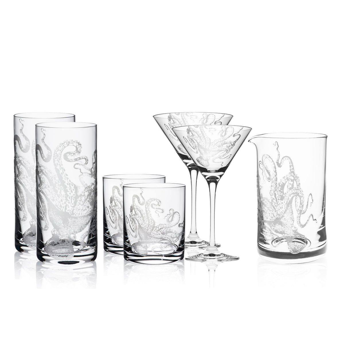 A collection of octopus glassware, including the &quot;I Love Lucy&quot; Cocktail Collection by Caskata Artisanal Home with etched octopus designs, features four highball glasses, two crystal cocktail glasses, and two tumblers, all arranged against a white background.