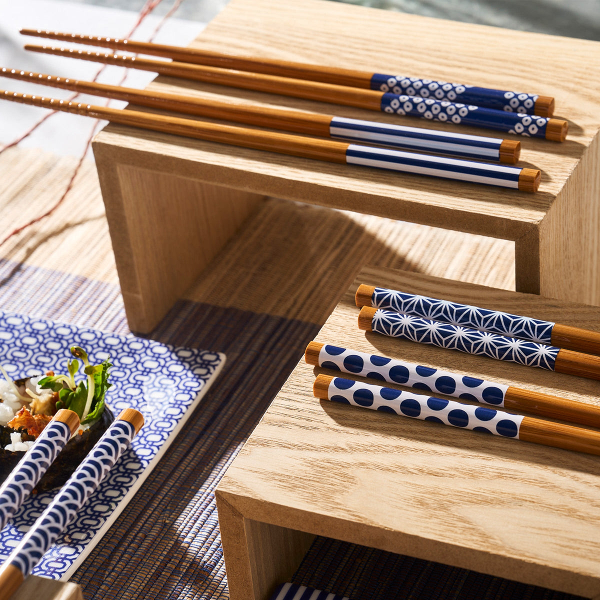 A pair of Kyoto Chopsticks resting on a rustic wooden table by Miya, Inc.