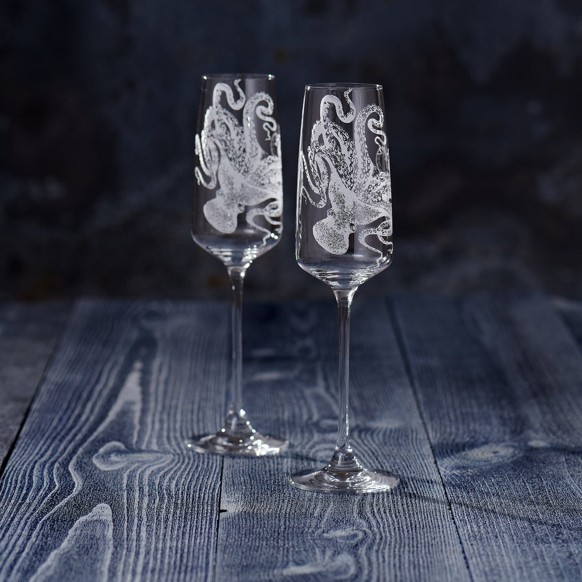 Two Lucy Champagne Glasses with a Caskata Artisanal Home design on them.