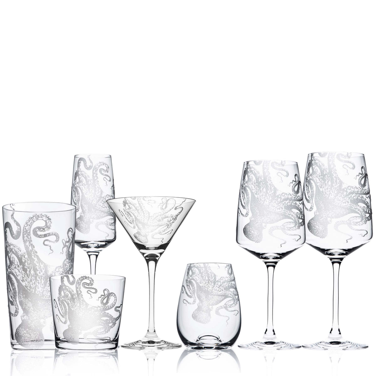 A set of Lucy Red Wine Glasses by Caskata Artisanal Home, featuring intricate designs on stemmed glasses. Hand washing recommended for optimal care.