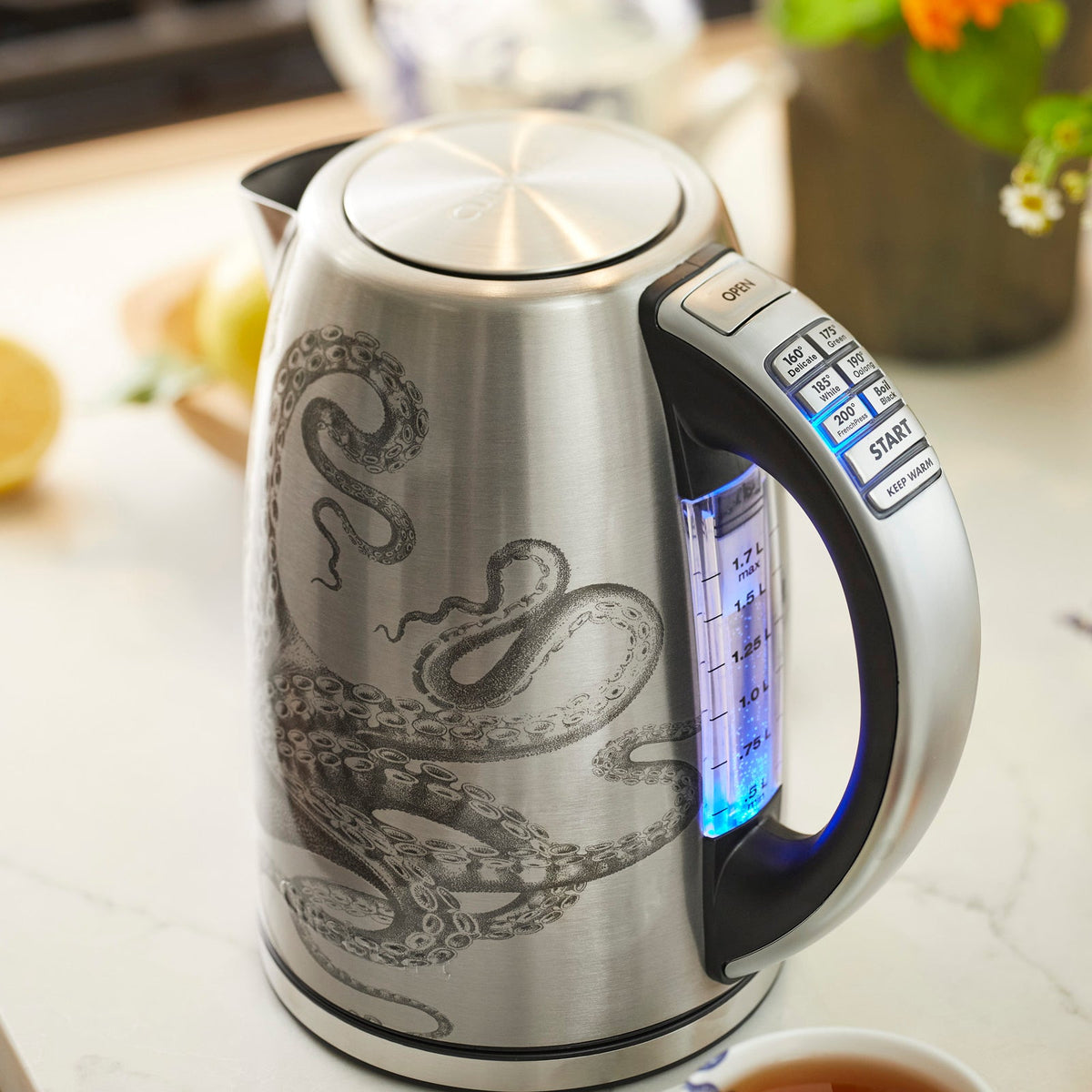 An electric kettle, the Caskata X Cuisinart Limited Edition Lucy Programmable Electric Kettle with a whimsical octopus design, perfect for brewing tea.