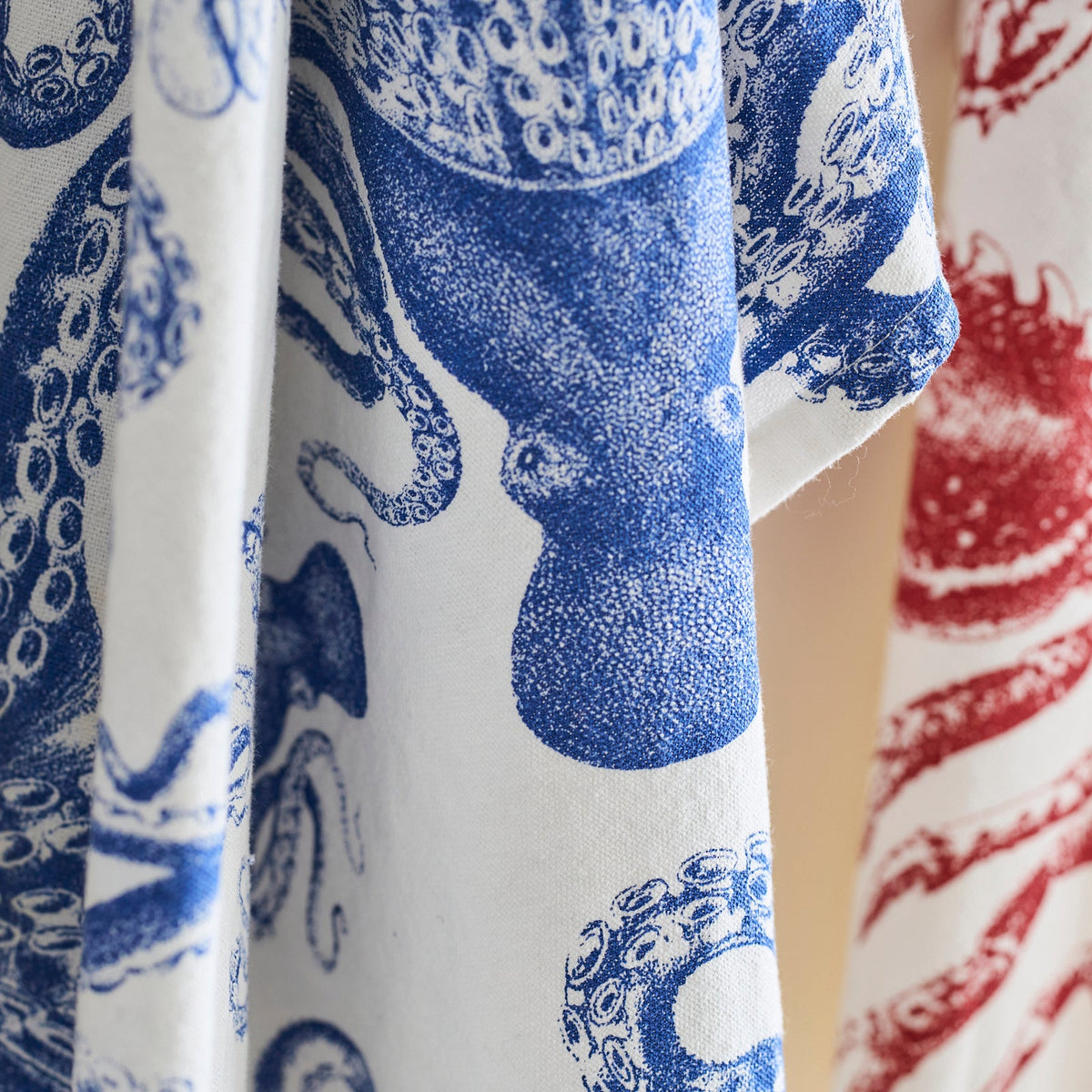 Close-up of fabric featuring blue and red octopus prints, perfect for Lucy Kitchen Towels, Set of 2 by Caskata.