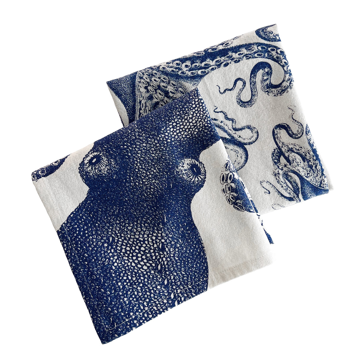 Two folded Caskata Lucy Kitchen Towels, Set of 2 featuring blue octopus designs on a white background, positioned side by side—perfect kitchen companions for any ocean lover.