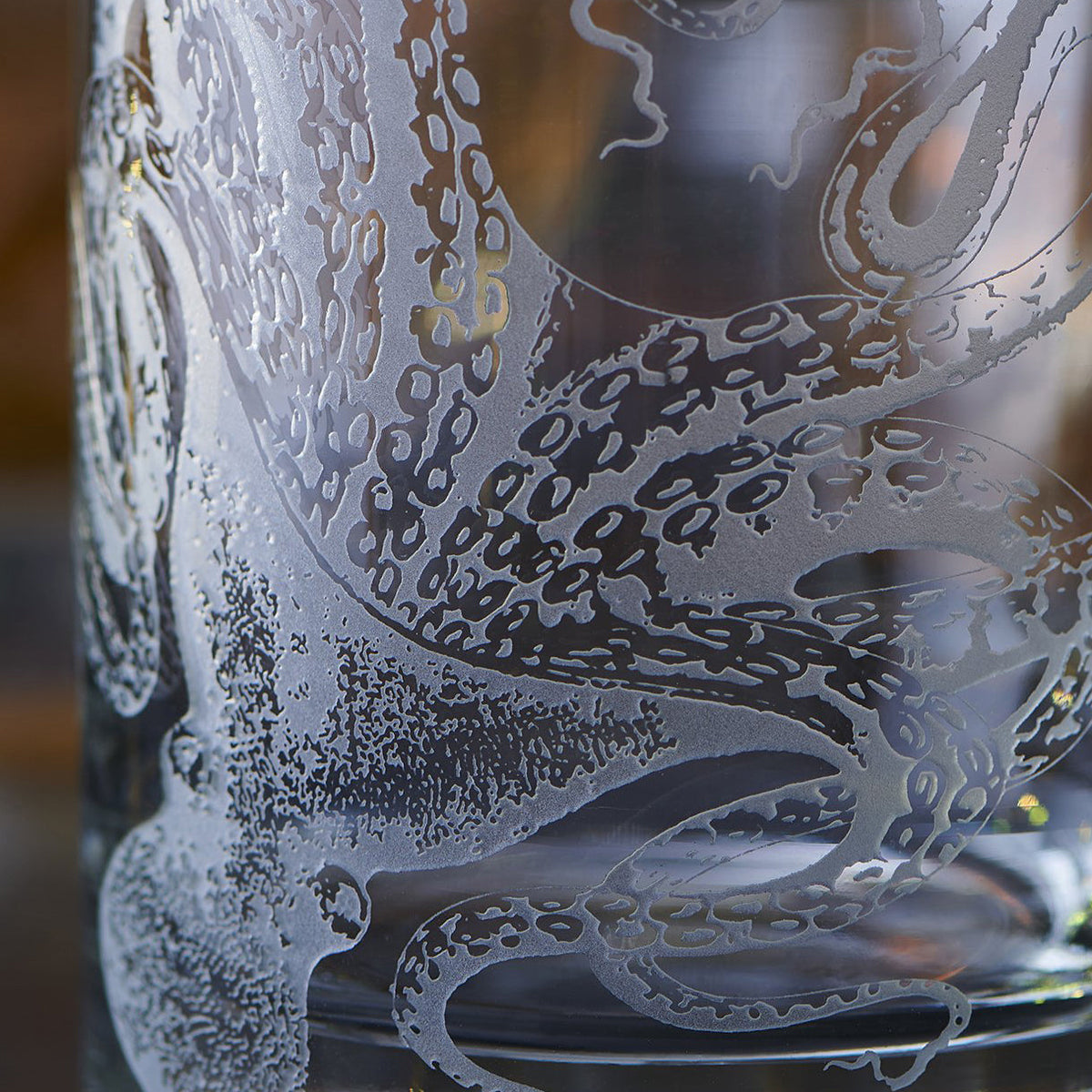 Close-up of an intricately etched octopus design on a piece of Lucy Rocks Glasses from Caskata Artisanal Home, showcasing the exquisite sand-etching technique.