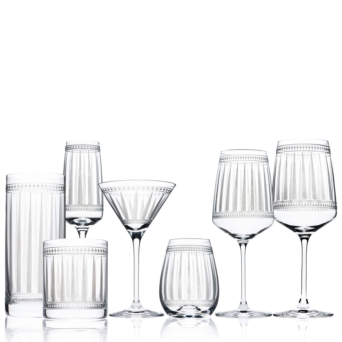 A set of Marrakech Short Drink Glasses from Caskata Artisanal Home displaying art deco forms on a white background.