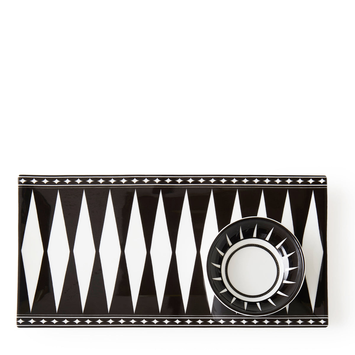 A black and white geometric patterned rectangular bone china tray with a matching small bowl placed on it, both featuring diamond and triangular designs, perfect for serving appetizers, this is the Marrakech Large Sushi Tray by Caskata.