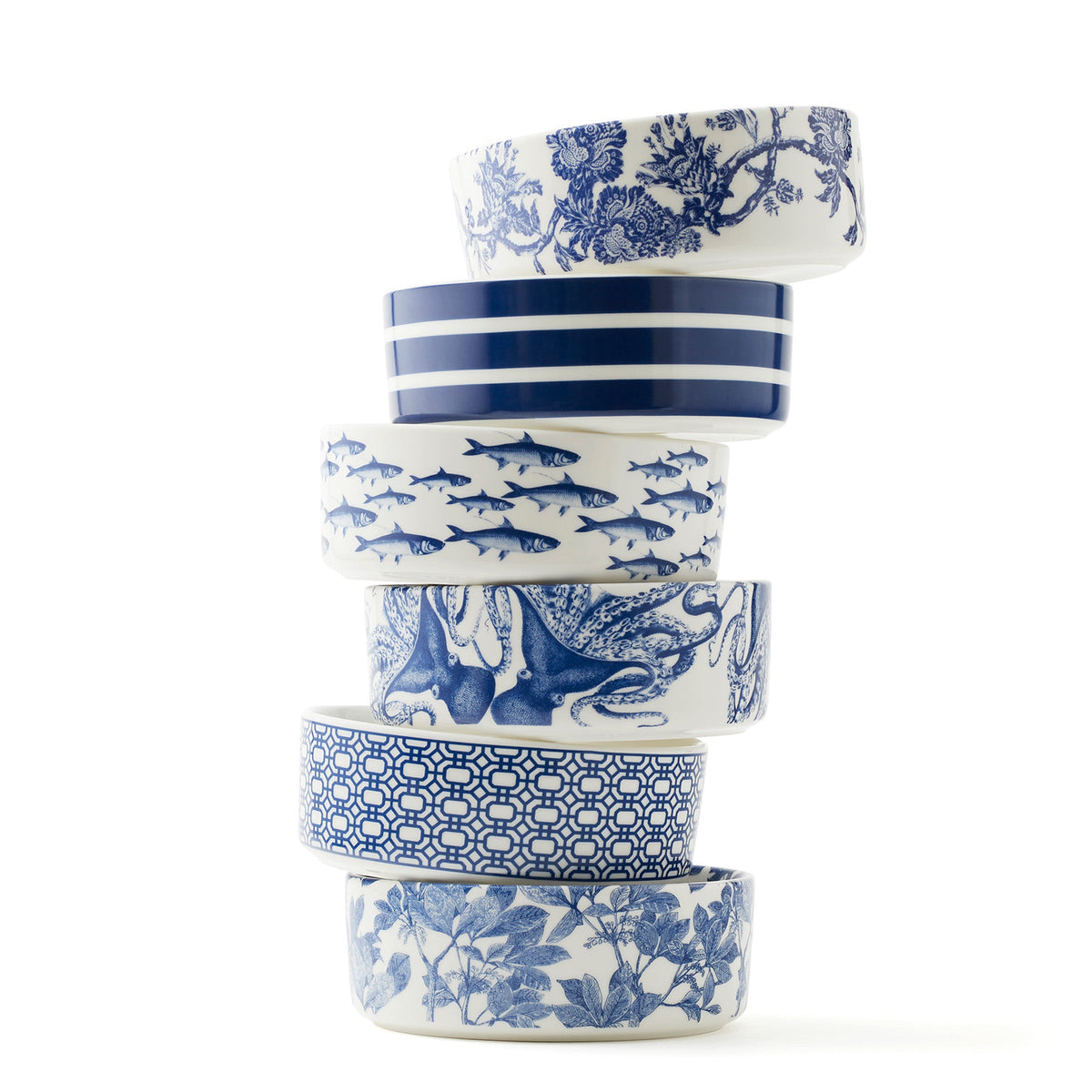 A stack of Newport Garden Gate Medium Pet Bowls in blue and white, featuring the 6 best-selling patterns by Caskata.