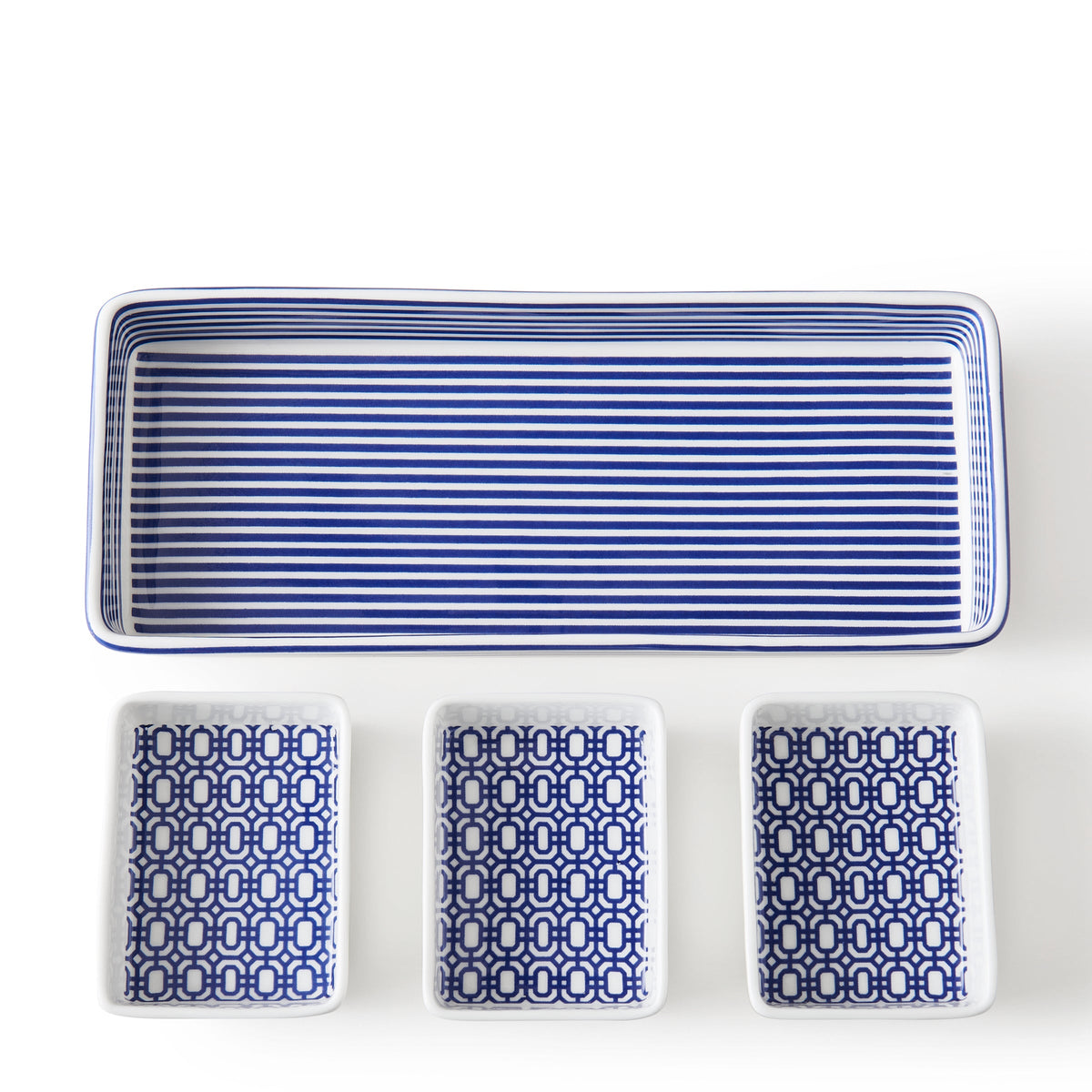 A Newport Nested Appetizer Tray &amp; Spoons Set by Caskata with three bone china blue and white dishes.