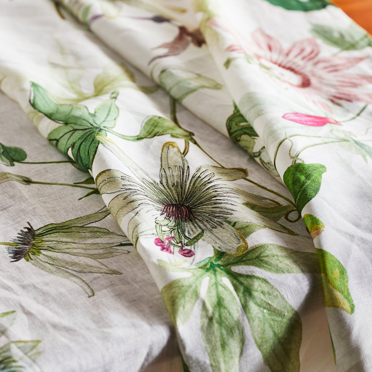 A close up of a TTT Passionflower Linen Tablecloth.