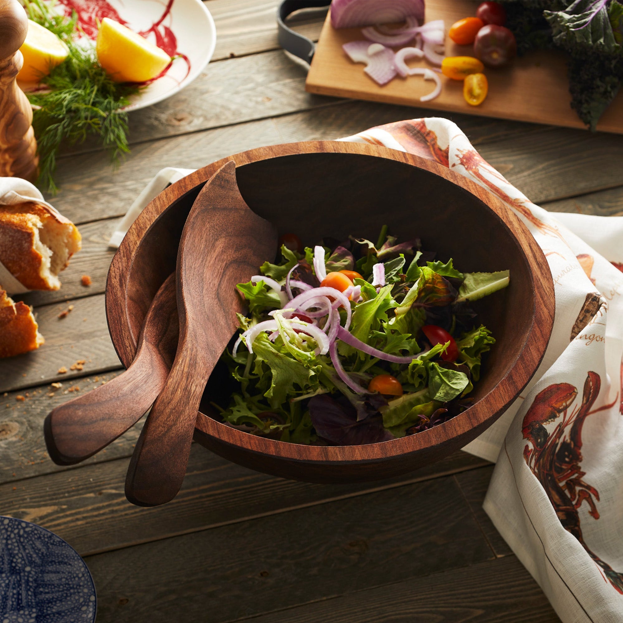 A Peterman's Black Walnut 13" Handcrafted Serving Bowl with a salad in it crafted by an artisan woodworker.