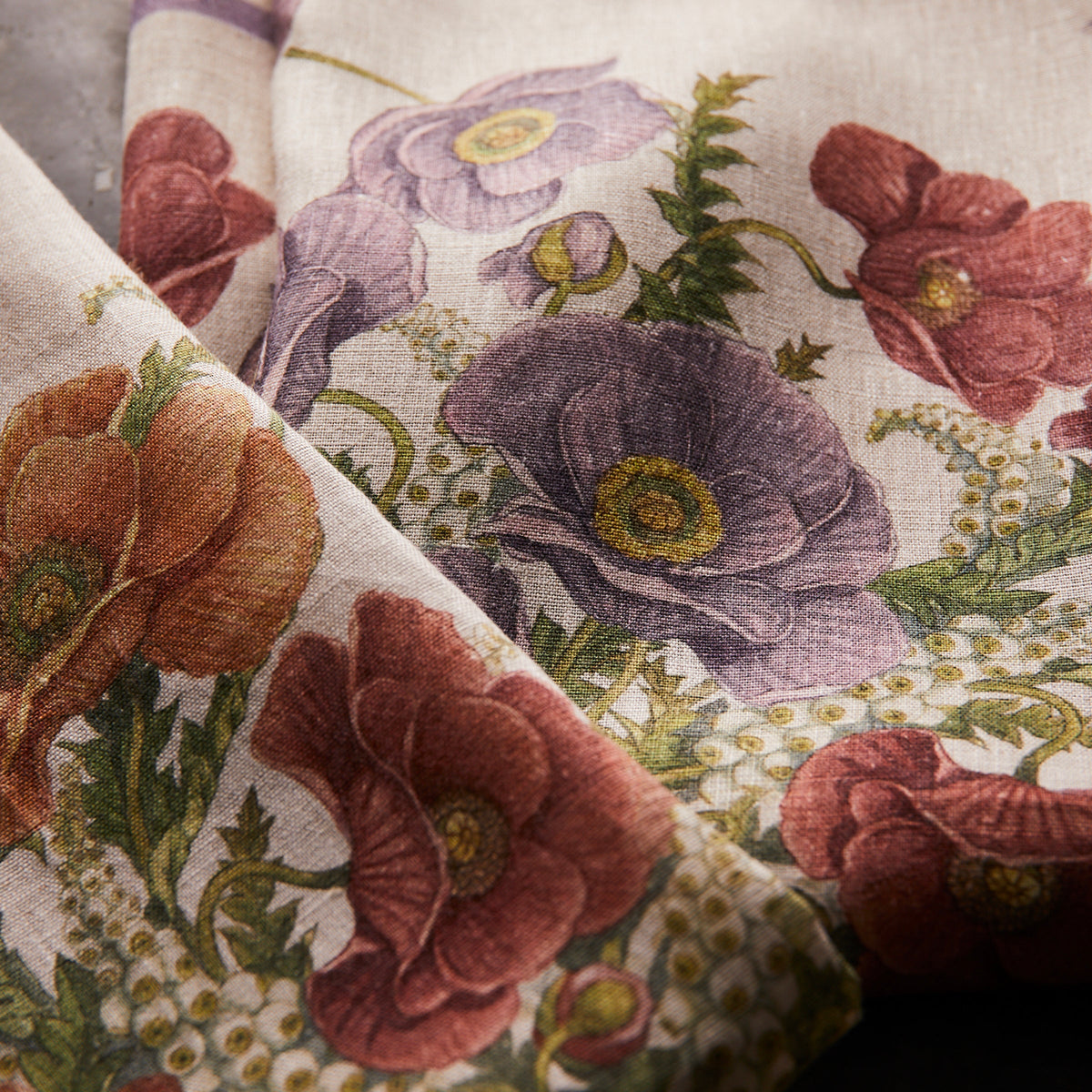 A close up of a TTT Poppies Linen Kitchen Towels Set/2 with autumnal colored poppies on it.