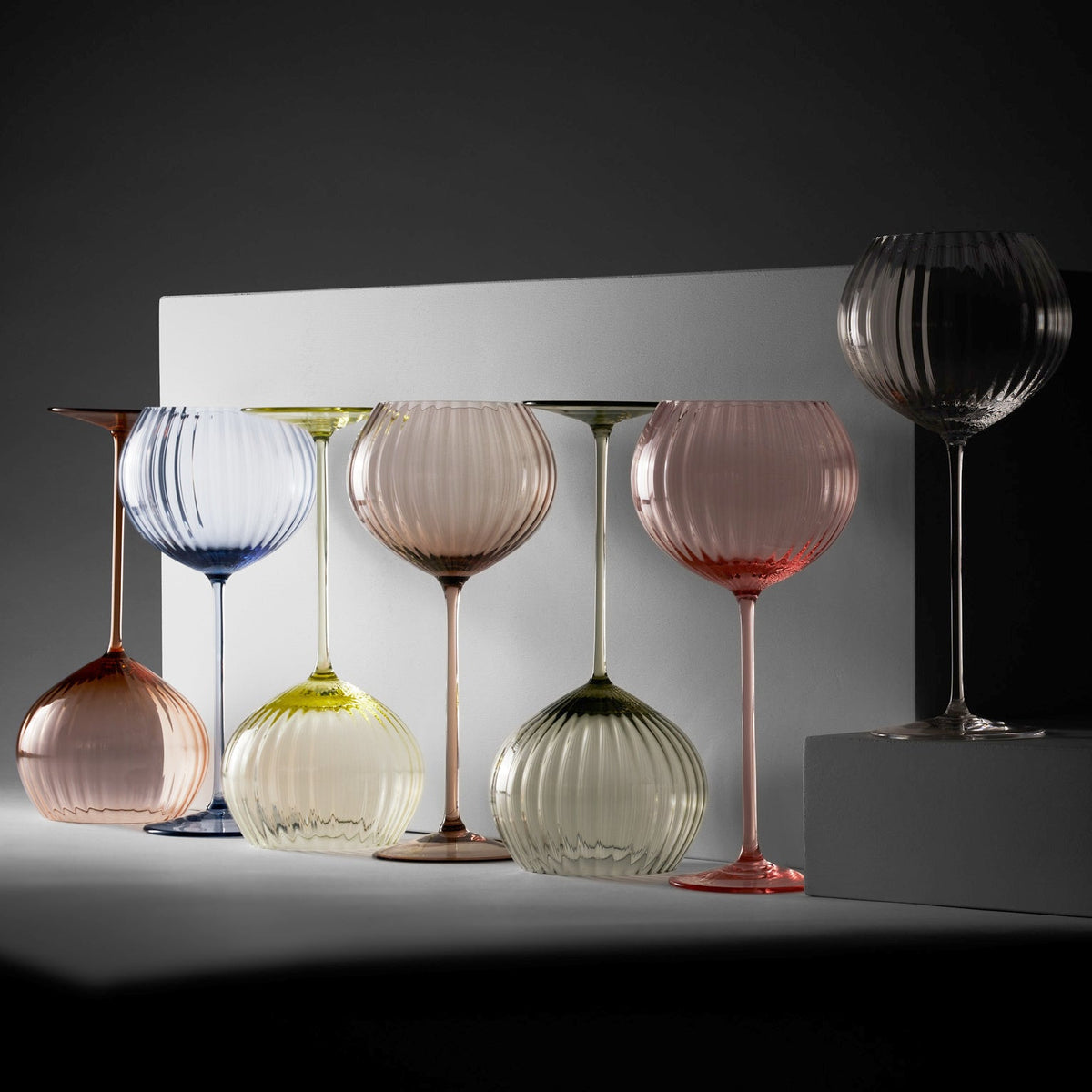 A collection of various colors of the Quinn red wine crystal glasses from Caskata.