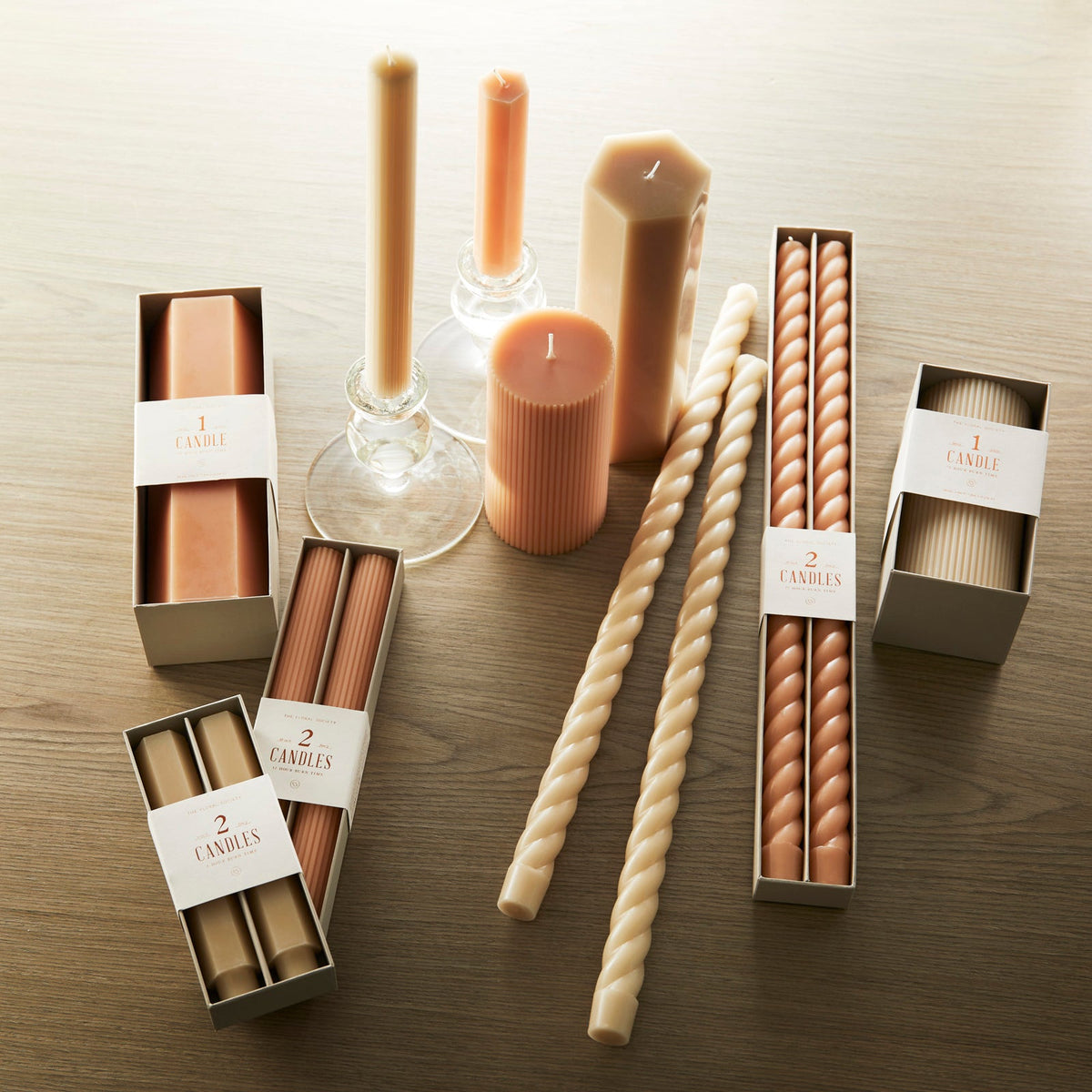 A collection of parchment white and petal pink candles by Caskata offer a range of options for every tabletop, including candlesticks and pillars.