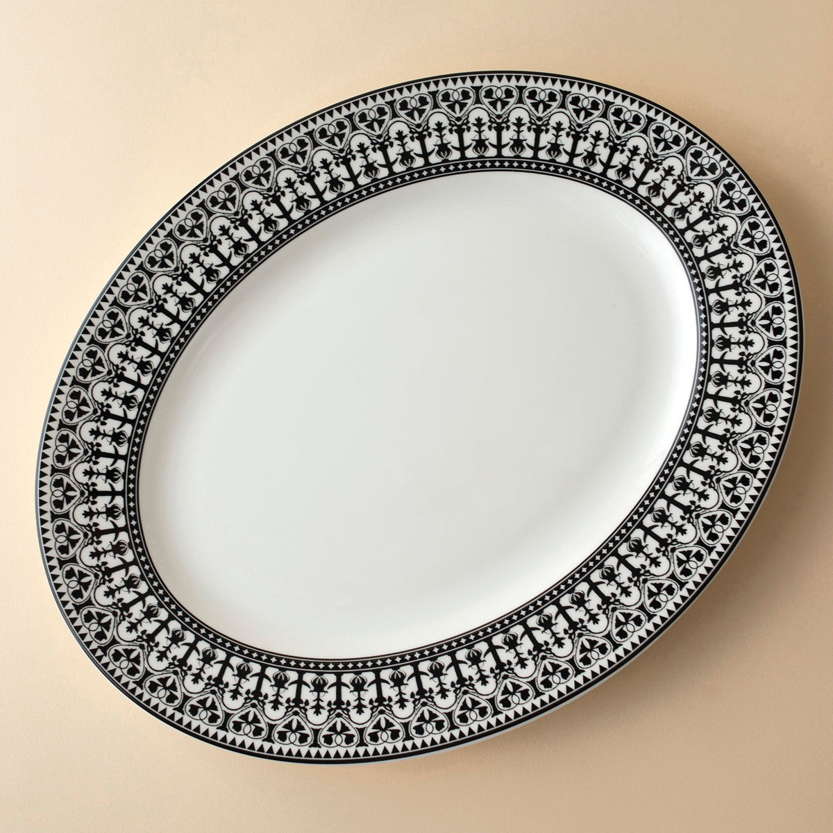 A Casablanca Black Large Oval Rimmed Platter by Caskata Artisanal Home on a neutral surface.