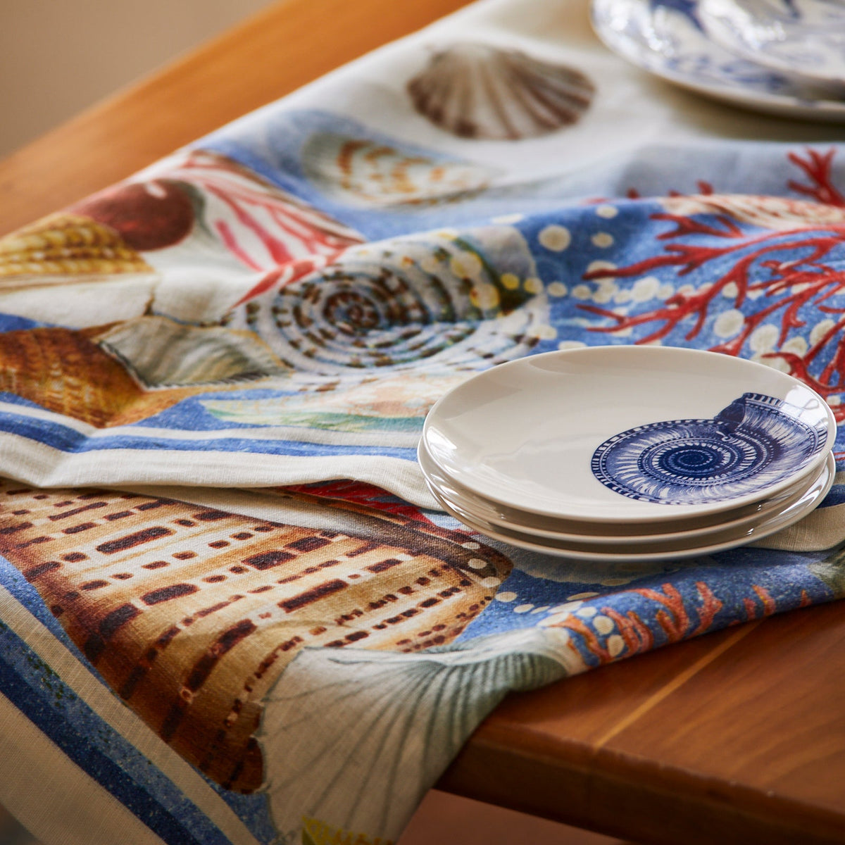 A blue and white Sanibel Linen Tablecloth.