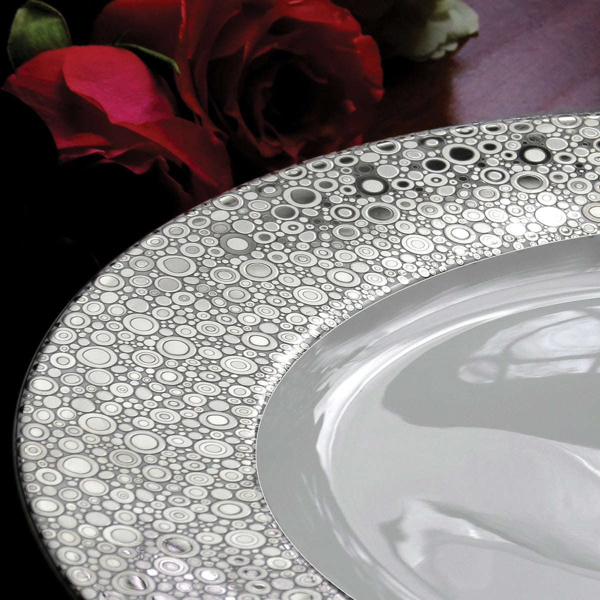 A Ellington Shine Platinum Bread &amp; Butter Plate with a rose on it, made of bone china from Caskata Artisanal Home.