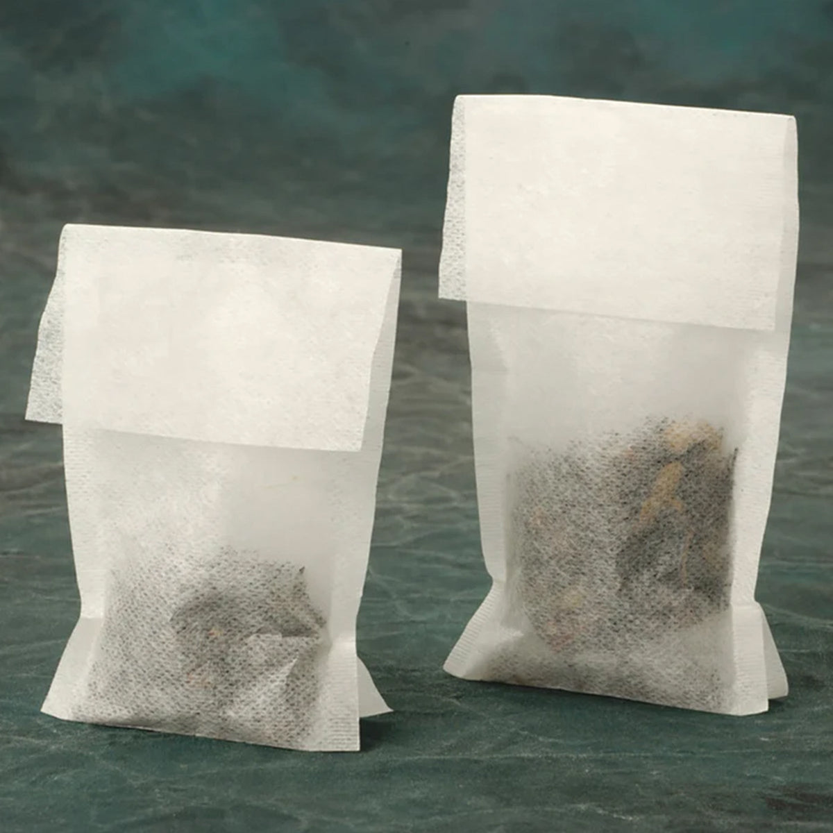 Two bags of RSVP International Small Tea Filters sitting on top of each other, ready for brewing.