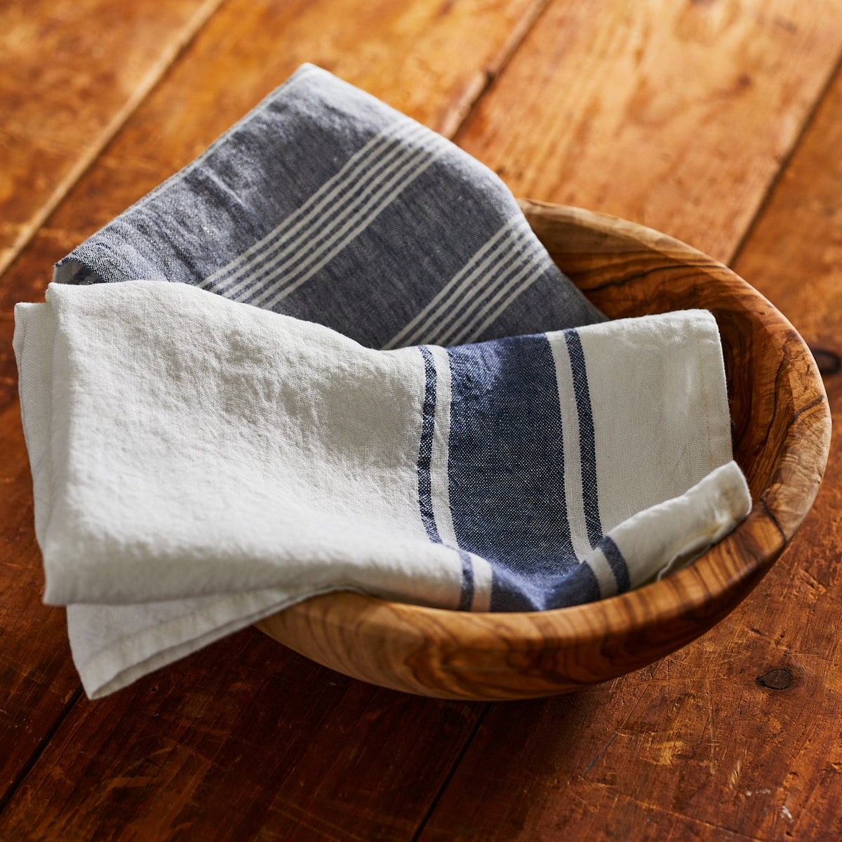 Two Trattoria Blue Linen Kitchen Towels Set/2 by TTT displayed in a wooden bowl.