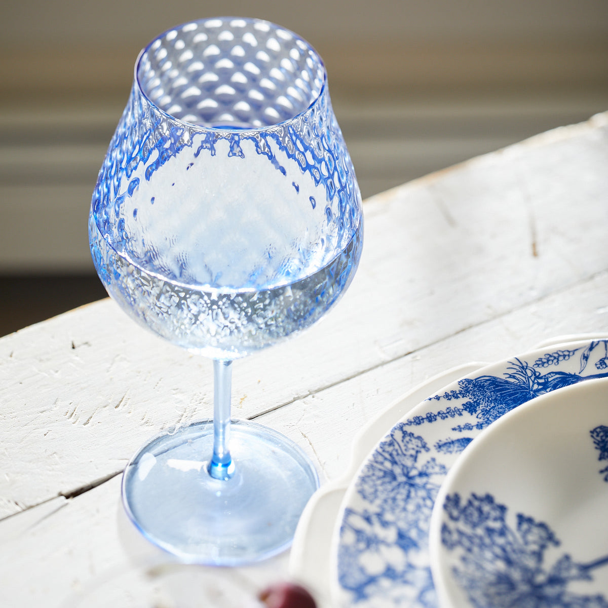 Phoebe cobalt blue mouth-blown optic crystal universal wine glasses set with summber blues platesfrom Caskata.