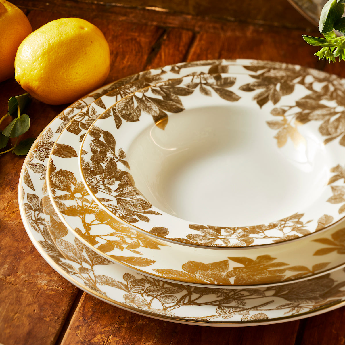 Arbor Gold Rimmed Soup Bowl paired with the dinner plate and charger from Caskata.