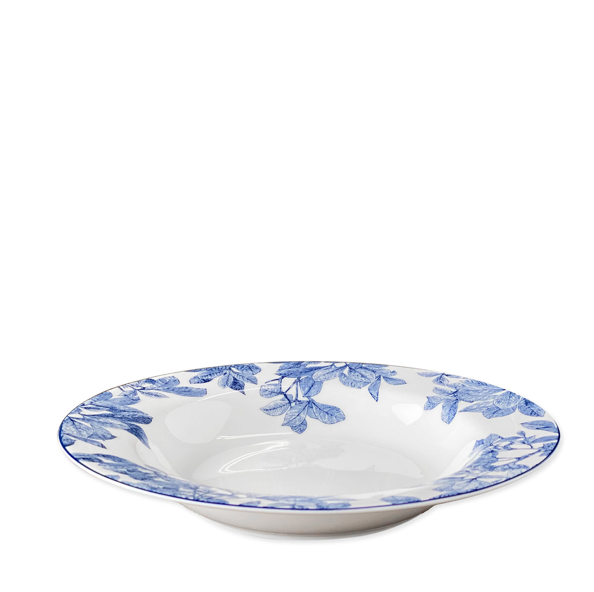 The Arbor Rimmed Soup Bowl, crafted by Caskata Artisanal Home from high-fire porcelain, features a white ceramic body with a blue floral pattern around the rim. This elegant piece is also dishwasher safe for easy cleaning.