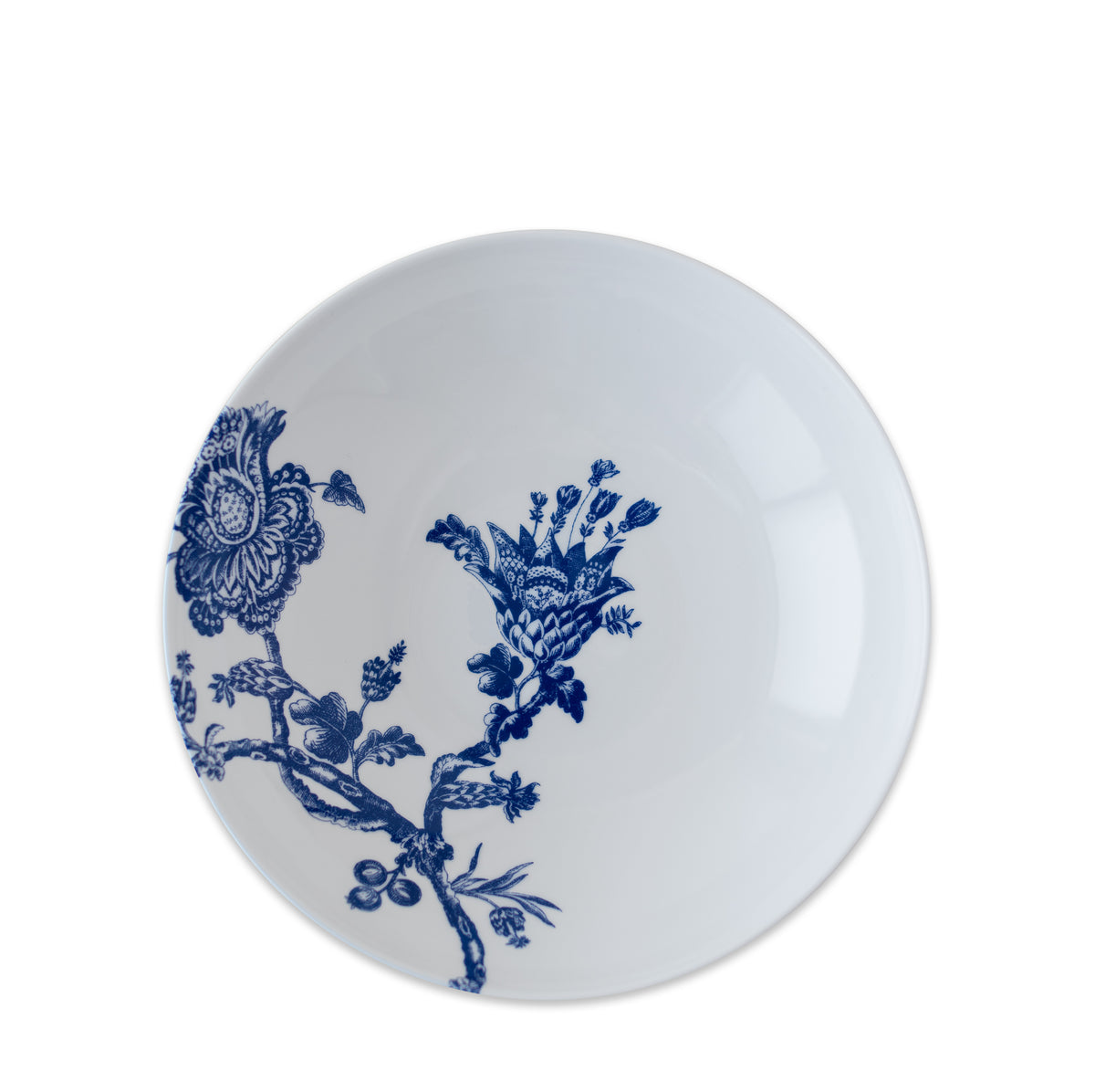 A round white ceramic plate with intricate blue floral designs on one side, reminiscent of the Arcadia Entrée Bowl from Caskata Artisanal Home collection.
