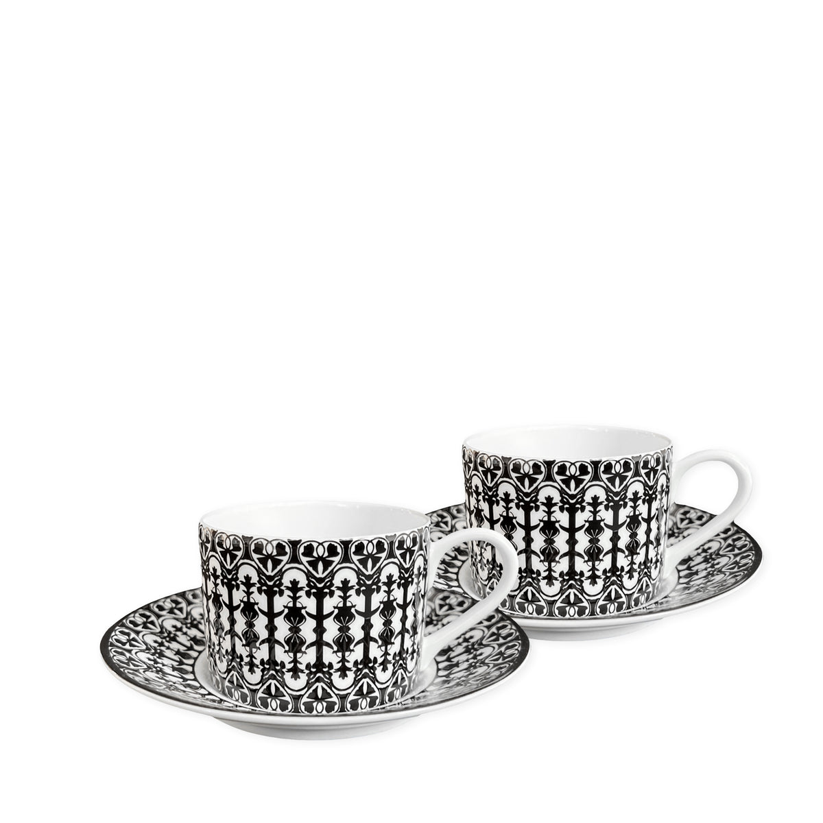 Two white **Casablanca Cups &amp; Saucers, Set of 2** by **Caskata**, featuring black and white intricate patterns, add timeless elegance to any dinnerware collection.