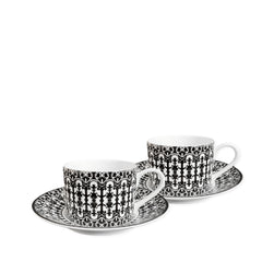 Two white **Casablanca Cups & Saucers, Set of 2** by **Caskata**, featuring black and white intricate patterns, add timeless elegance to any dinnerware collection.